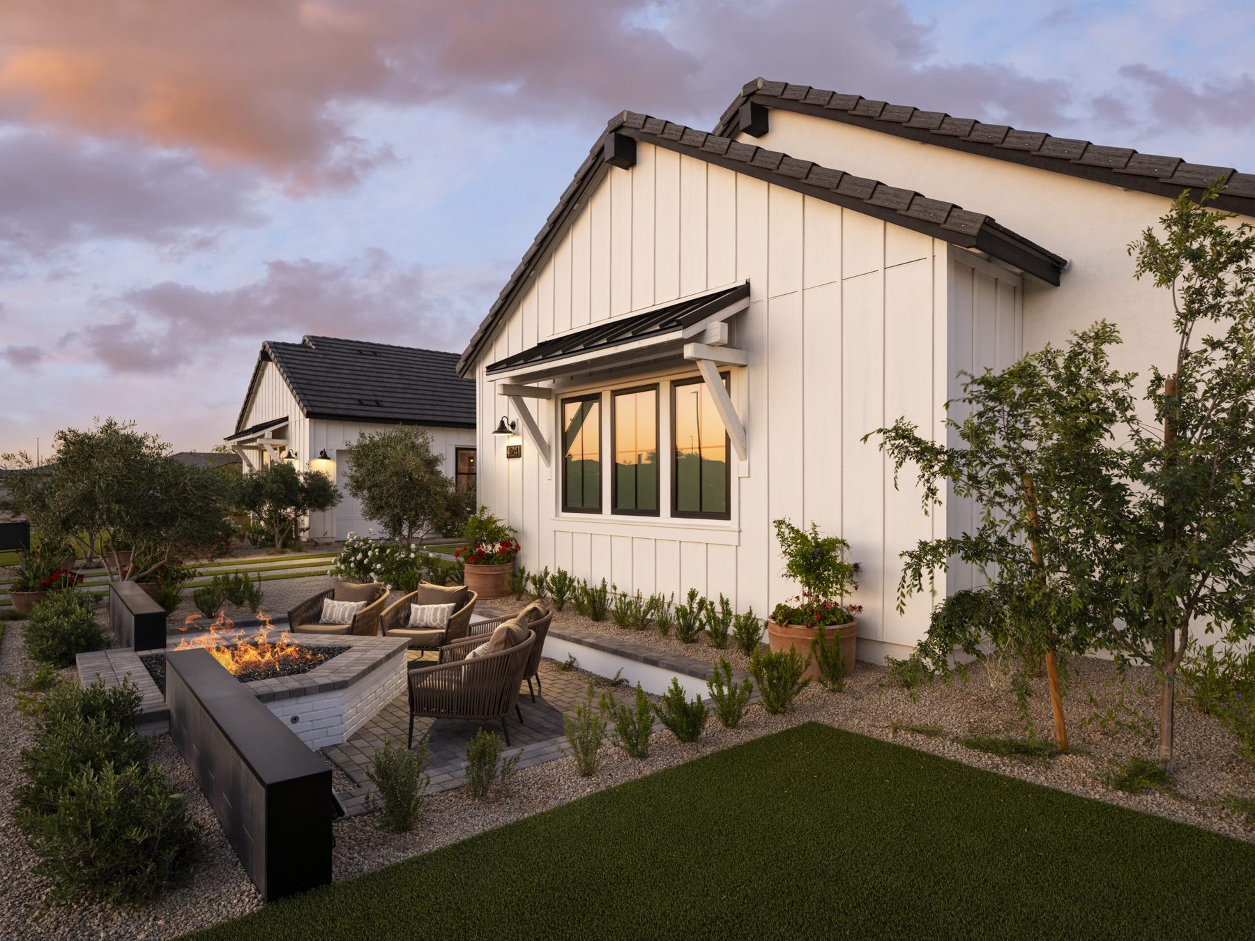 Modern desert home at dusk with fire feature